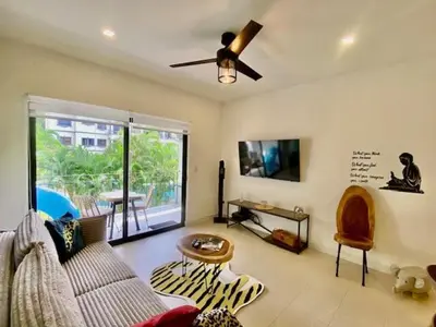a living room with a couch and a ceiling fan at Palmas Resort De Tamarindo Serenity Gem in Villarreal