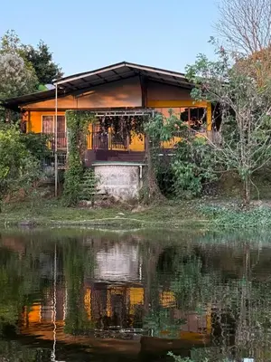 a house with a pond in front of it at Cabaña del Lago in Marsella
