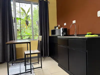 a kitchen with a counter and a sink and a window at Cabaña del Lago in Marsella