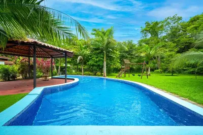 a swimming pool in a yard with a playground at Monte Donato 18 - Apt 2 in Playa Avellana