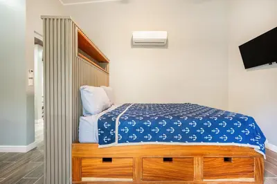 a bedroom with a bed with a blue cover on it at Monte Donato 18 - Apt 2 in Playa Avellana