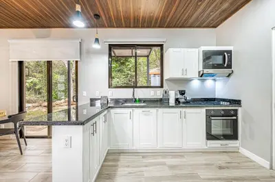 a kitchen with white cabinets and a counter top at Monte Donato 18 - Apt 2 in Playa Avellana