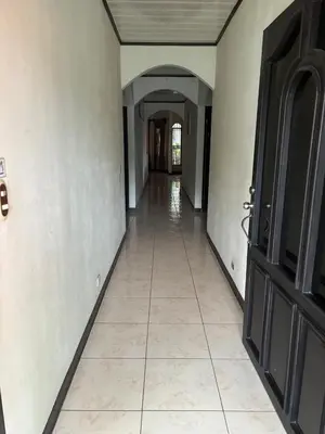 an empty hallway with a tile floor and a door at Villa tico House in Cariari