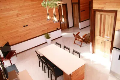 a dining room with a white table and chairs at Casa Buena Vista San Gerardo de Dota in San Gerardo de Dota