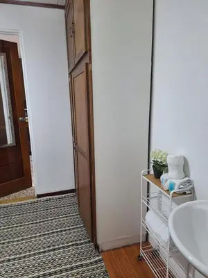 a bathroom with a white sink and a door at Habitación cama individual a 10 min del Aeropuerto in Alajuela City