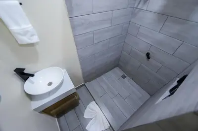 a bathroom with a white sink and a shower at Cabana Nicolia in San Francisco