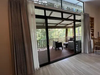 a living room with a sliding glass door to a balcony at Cabana Nicolia in San Francisco