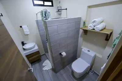 a bathroom with a white toilet and a sink at Cabana Nicolia in San Francisco