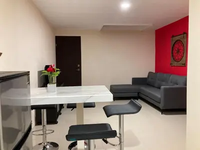 a living room with a table and chairs and a couch at Hospedaje Ana Lu 3, Only 10 minutes from airport, in Alajuela City