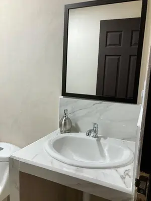 a bathroom with a white sink and a mirror at Hospedaje Ana Lu 3, Only 10 minutes from airport, in Alajuela City
