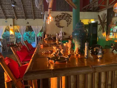 a long wooden table with a vase on top of it at Hotel Clandestino beach resort in Parrita