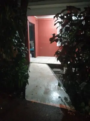 a door to a house with a pink door at Monkey Beach House in Tortuguero