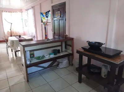 a room with a counter and a table with a mirror at Monkey Beach House in Tortuguero