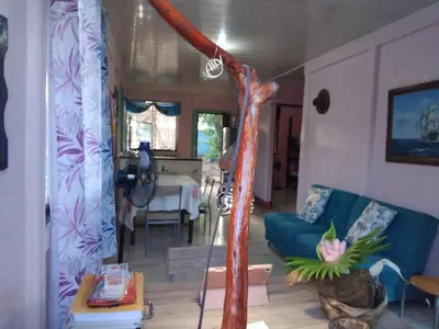 a living room with a blue couch and a table at Monkey Beach House in Tortuguero