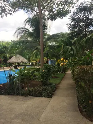 a sidewalk leading to a resort with a pool at CocoMarindo in Coco