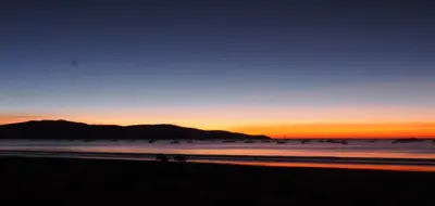 a sunset on a beach with the ocean at CocoMarindo in Coco