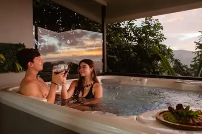 a man and a woman sitting in a bath tub at Villa Alma de Campo Monteverde in Monteverde Costa Rica