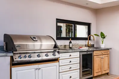 a kitchen with a stove and a sink at The Point 5-Star All-Inclusive Experience in Tamarindo
