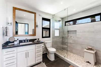a bathroom with a toilet and a glass shower at The Point 5-Star All-Inclusive Experience in Tamarindo
