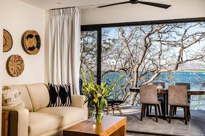 a living room with a couch and a table at The Point 5-Star All-Inclusive Experience in Tamarindo