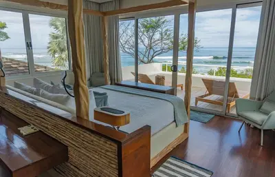 a bedroom with a bed with a view of the ocean at The Point 5-Star All-Inclusive Experience in Tamarindo