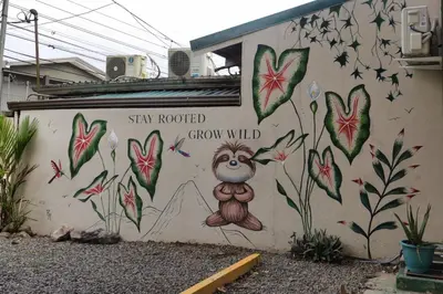 a wall with a painting of a monkey on it at Ceiba Hostel in Fortuna