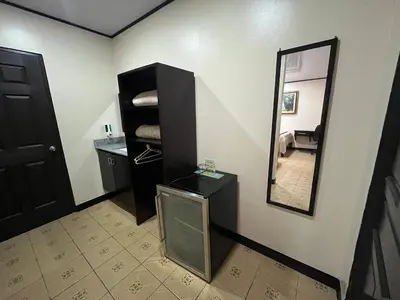 a bathroom with a mirror and a black cabinet at HOTEL DEL RiO in Liberia