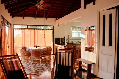 a kitchen and living room with a table and chairs at Terraza Suite Frente al Mar in Puntarenas