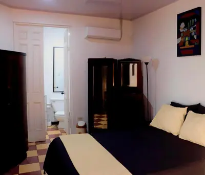 a bedroom with a bed and a bathroom at Terraza Suite Frente al Mar in Puntarenas