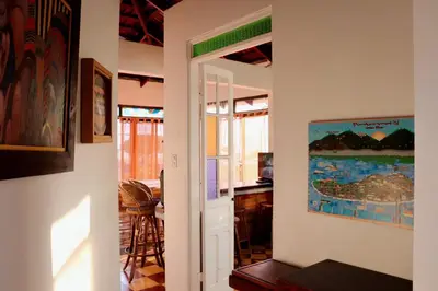 a room with a door leading to a dining room at Terraza Suite Frente al Mar in Puntarenas