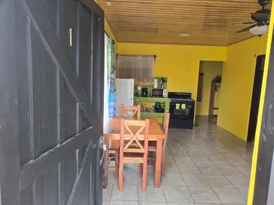 a kitchen and dining room with a table and a door at Rusticas Dani in Tanque