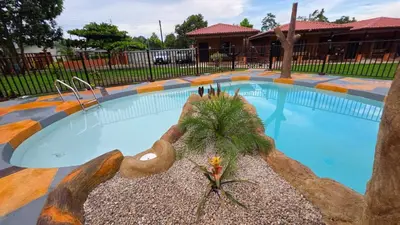 a swimming pool with a palm tree in the middle at Rusticas Dani in Tanque