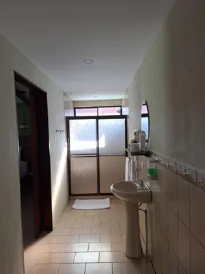 a bathroom with a toilet and a sink and a mirror at Olla é Mono Ecolodge in Sarapiquí