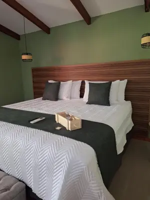 a bedroom with two beds with a box on it at Olla é Mono Ecolodge in Sarapiquí