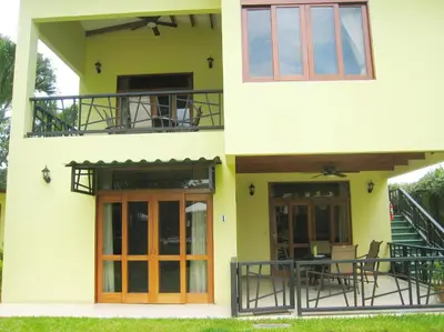 a house with a balcony and a patio at Club Del Cielo Unit 1 in Jacó
