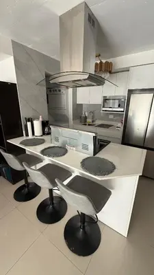a kitchen with three chairs and a counter in a kitchen at Khaya Curridabat in Curridabat