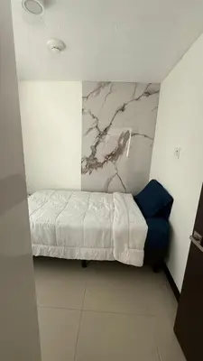a bedroom with a bed and a marble wall at Khaya Curridabat in Curridabat