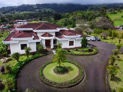 an aerial view of a house with a driveway at Hotel Poas Paradise in Alajuela City