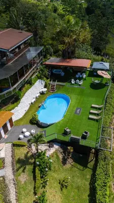 an aerial view of a house and a swimming pool at Glamping Renacer Vistas Turrialba, Paris in Turrialba