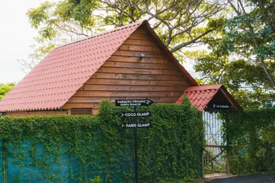 a small house with a red roof and a fence at Glamping Renacer Vistas Turrialba, Paris in Turrialba