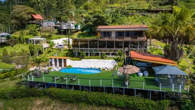 an aerial view of a house with a swimming pool at Glamping Renacer Vistas Turrialba, Paris in Turrialba