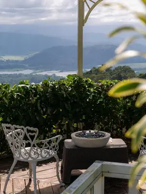 a chair and a bowl on a table with a view at Glamping Renacer Vistas Turrialba, Paris in Turrialba