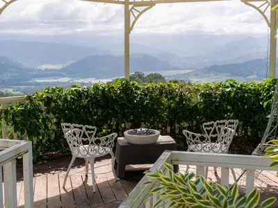 a patio with two chairs and a bowl on a table at Glamping Renacer Vistas Turrialba, Paris in Turrialba