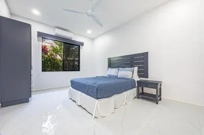a bedroom with a bed and a window at CASA SERENITY , brand new house, walk 2 beach, private pool, wifi, PURA VIDA!!!! in Uvita