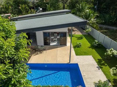 a house with a swimming pool in a yard at CASA SERENITY , brand new house, walk 2 beach, private pool, wifi, PURA VIDA!!!! in Uvita