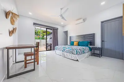 a bedroom with a bed and a desk at CASA SERENITY , brand new house, walk 2 beach, private pool, wifi, PURA VIDA!!!! in Uvita