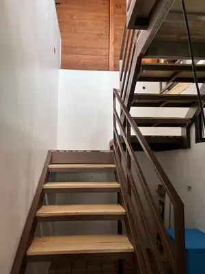 a set of stairs in a room with wooden ceilings at House view of the sunrise, 4 rooms in San Gerardo