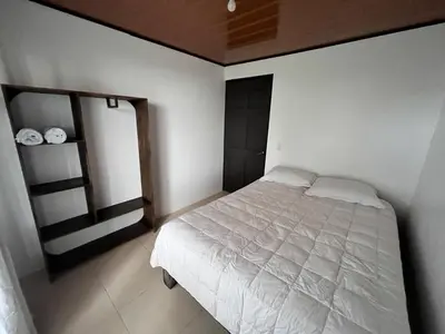 a bedroom with a white bed in a room at House view of the sunrise, 4 rooms in San Gerardo