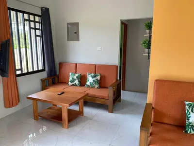 a living room with a couch and a coffee table at Cabañas Corozalito in Corozalito