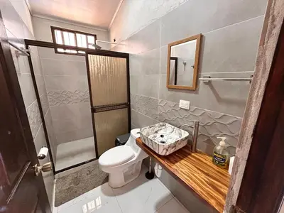 a bathroom with a toilet and a shower at Cabañas Corozalito in Corozalito